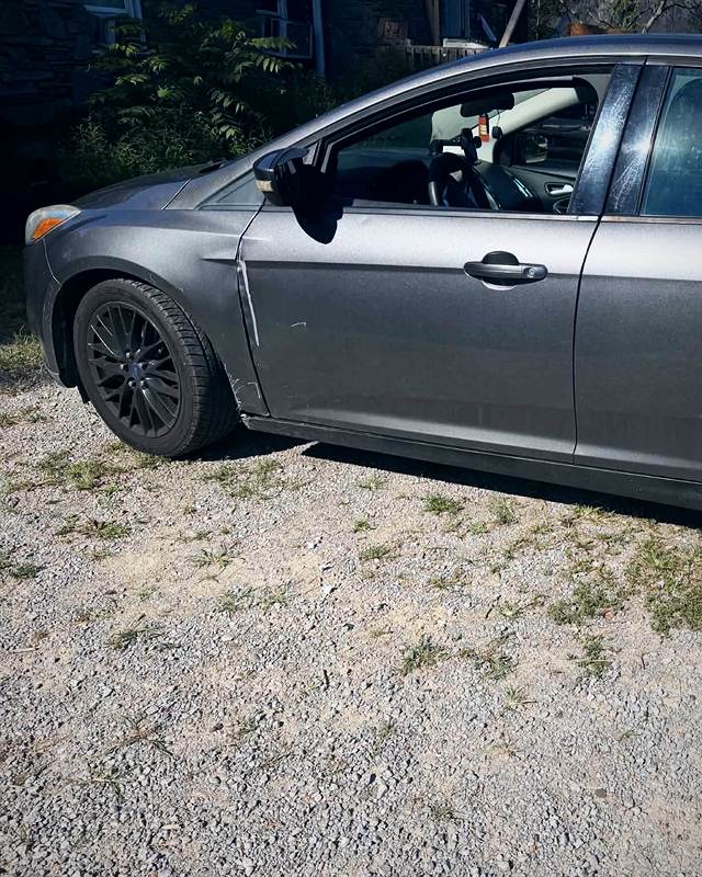 Gray Ford Focus sedan after an exterior wash