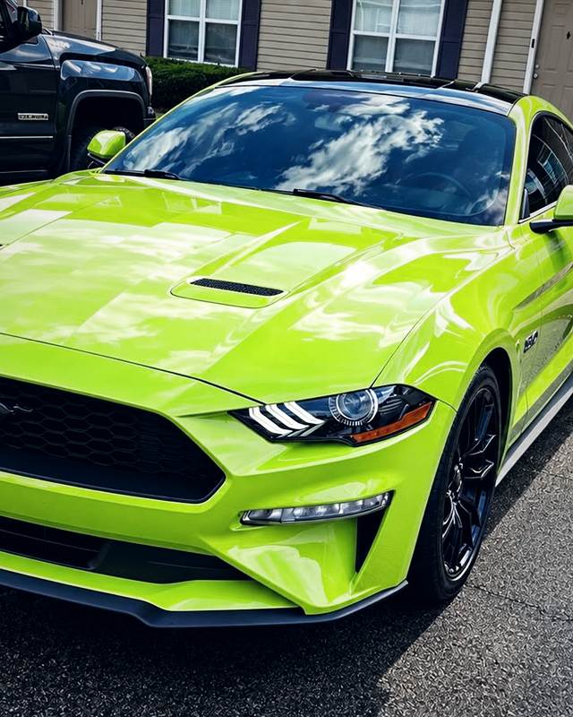Lime green Mustang GT, freshly detailed with a mirror-gloss hood