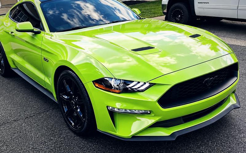 Lime green Ford Mustang GT with a glossy, freshly detailed finish
